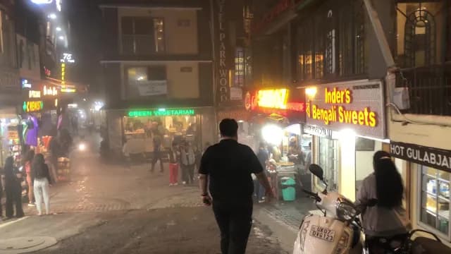 Bustling Night Street Scene in Mussoorie India with Neon Signs