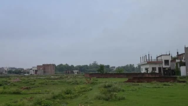 Suburban Construction Site in Rural Green Field Under Overcast Sky
