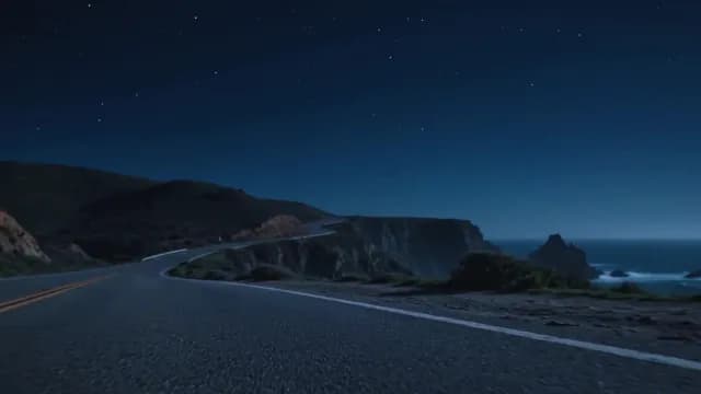 Starry Night Over Winding Coastal Highway and Cliffs