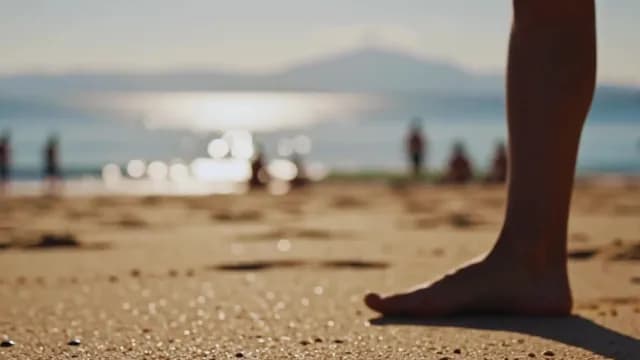 Barefoot Person Standing on Sunny Beach with Ocean Horizon