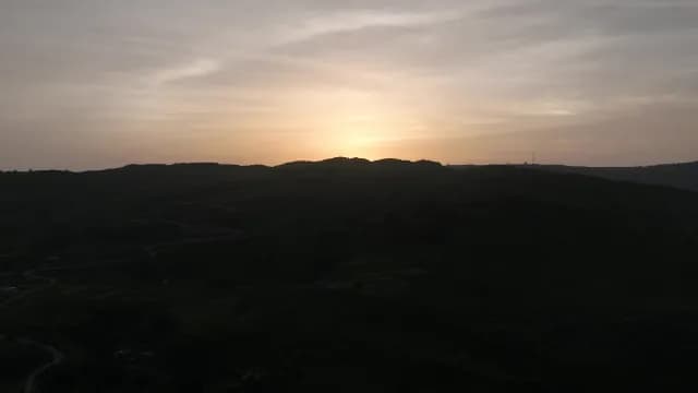 Aerial View of Golden Sunset Over Dark Rolling Hills, Udaipur