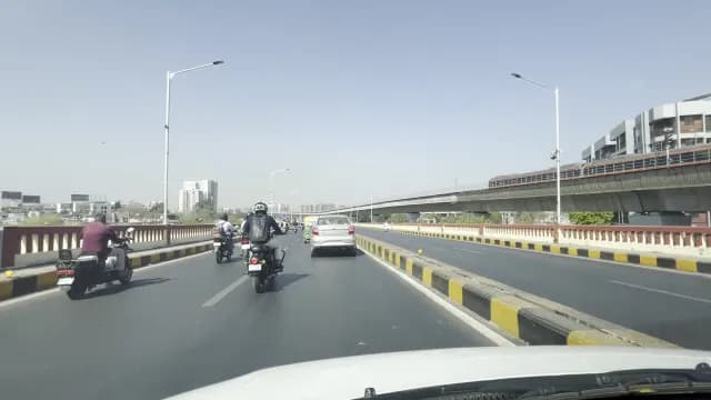 Busy Urban Traffic on Bridge with Elevated Metro Rail