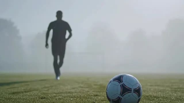 Soccer Player Approaching Ball in Morning Mist
