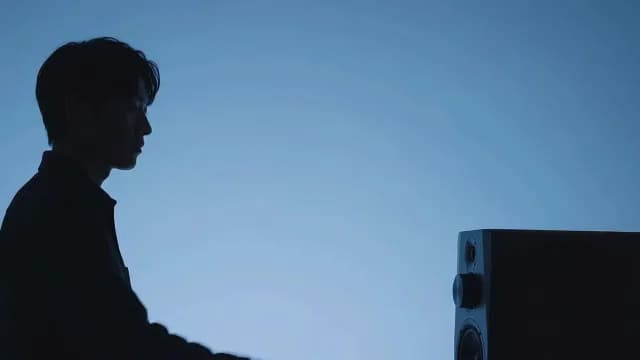 Profile Silhouette of Man Listening to Music in Blue Studio