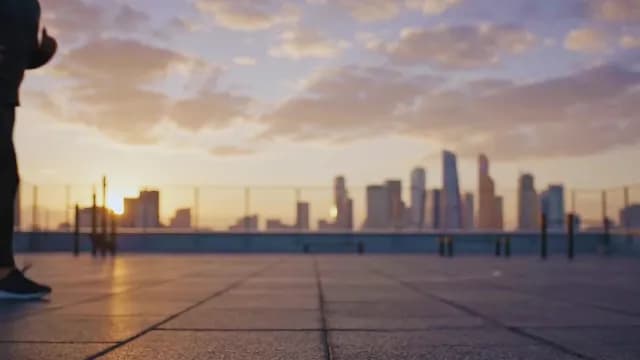 Sunset Rooftop Run with Urban Skyline View