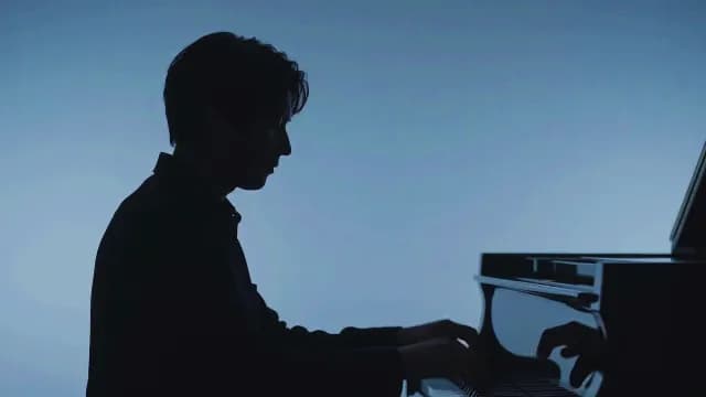 Silhouette of Male Pianist Playing Grand Piano on Blue Background