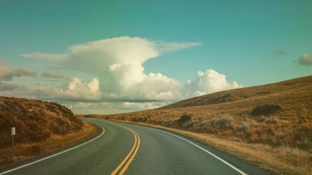 Scenic Winding Rural Highway Under Dramatic Storm Clouds