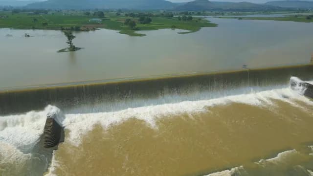 Aerial View of Water Cascading Over Large Rajdari Devdari Dam Spillway