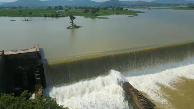 Aerial View of Water Cascading Over a Massive Rajdari Devdari Dam Spillway