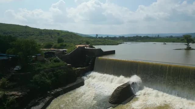 Aerial View of a Masonry Dam with Water Cascading Over Rajdari Devdari Dam Spillway