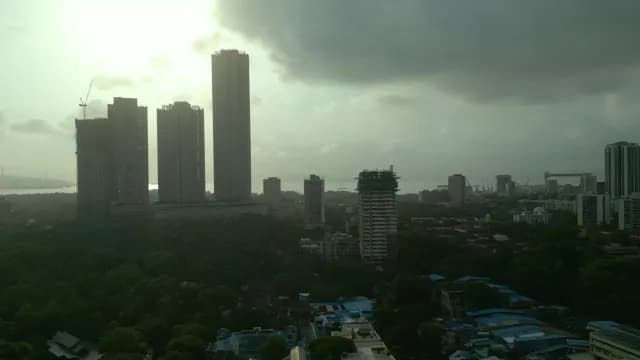 Dramatic Stormy Mumbai Skyline Over Lush Green Canopy