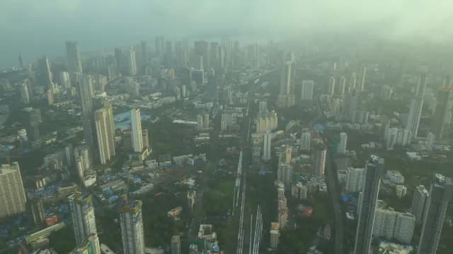 Aerial View of Mumbai City Skyline Under Misty Morning Fog