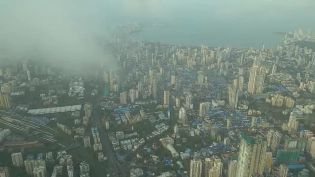 Aerial View of Foggy Mumbai Skyline and Coastline