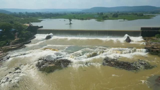 Aerial View of Water Cascading Over Wide Rajdari Devdari Dam