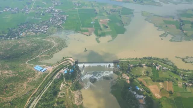 Aerial View of River Dam Spillway and Rural Agricultural Landscape