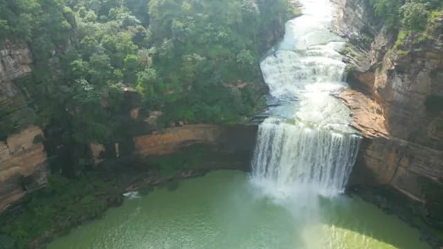 Aerial View of Multi-Tiered Waterfall in Lush Canyon of Rajdari Devdari Dam