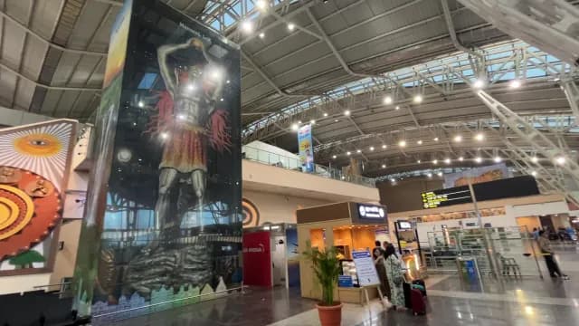 Indore Airport Interior Featuring Mahakal Lok Mural and Passengers