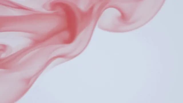 Abstract Red Ink Swirling in Liquid on White Background