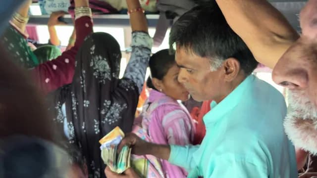 Bus Conductor Counting Cash in Crowded Indian Public Transport, Ajmer