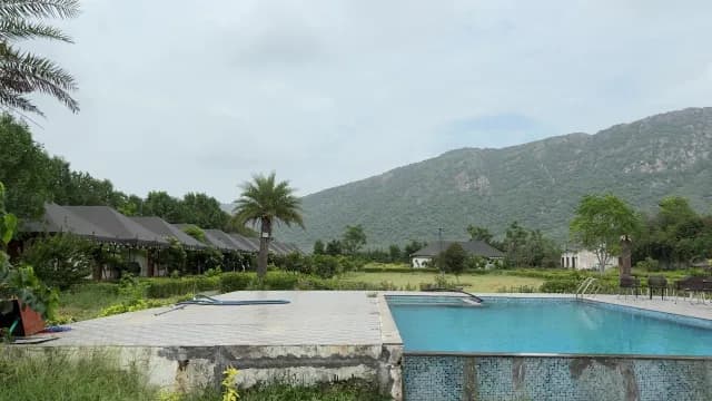 Luxury Mountain Resort Pool with Glamping Tents in Aravalli Hills
