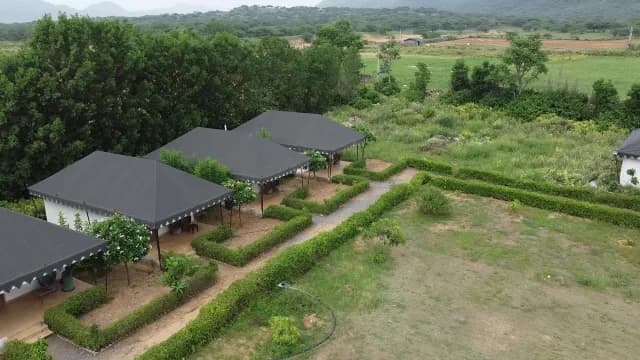 Luxury Safari Tents in Lush Green Landscape Aerial View