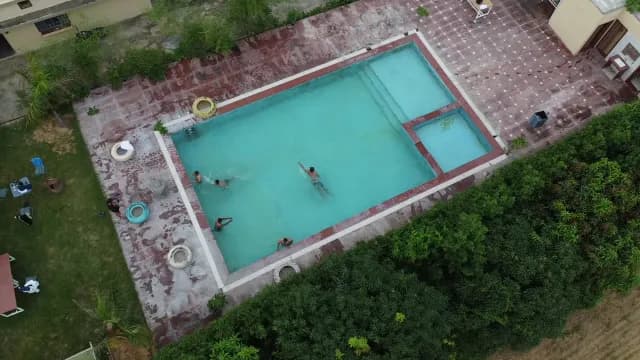 Aerial View of Swimmers in Outdoor Resort Swimming Pool