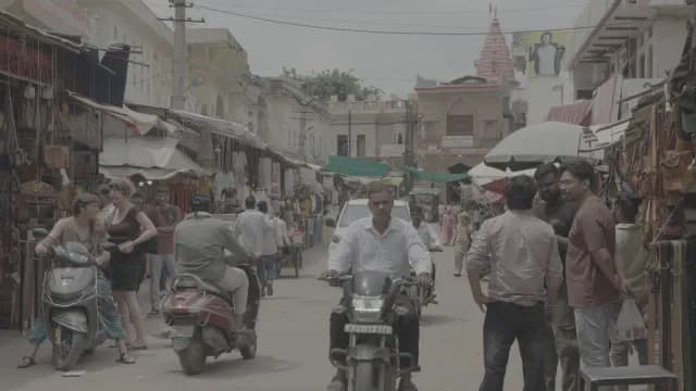 Busy Street Market with Motorbikes and Shoppers in Rajasthan India