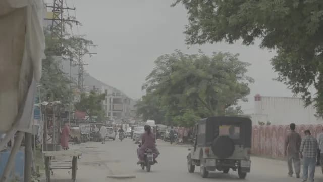 Busy Street Scene with Vehicles and Pedestrians in Pushkar India