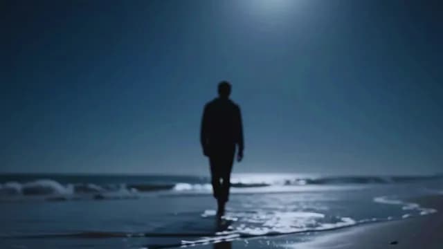 Lone Silhouette Walking on Moonlit Beach at Night