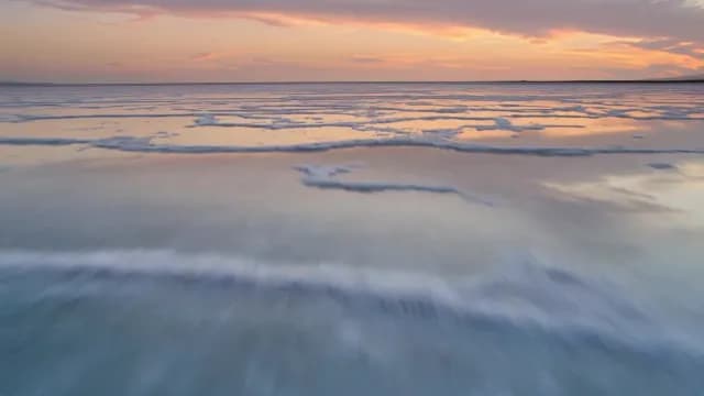 Aerial Sunset View Over Expansive Reflective Salt Flats