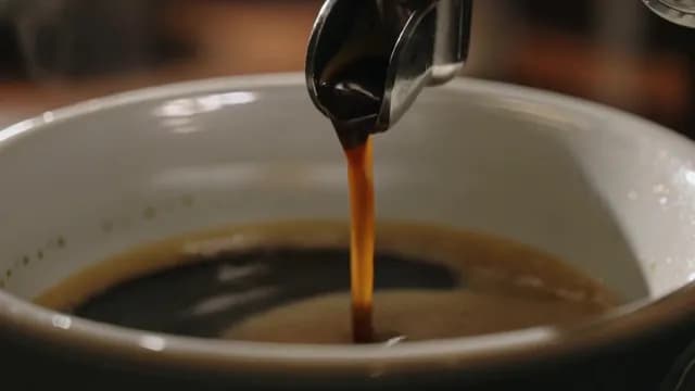 Macro Shot of Fresh Espresso Pouring into Ceramic Cup