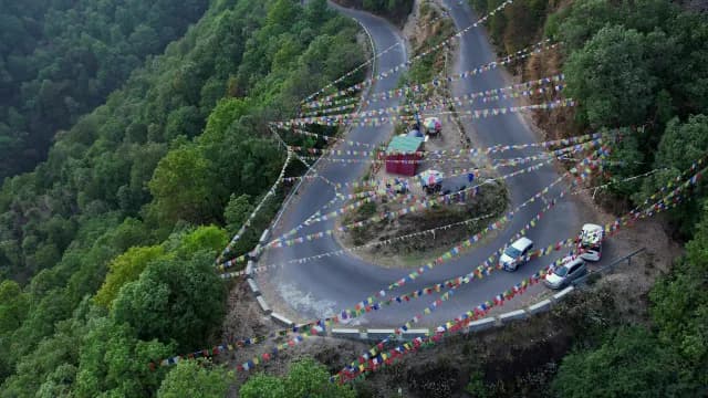 Winding Mountain Road with Colorful Tibetan Prayer Flags at Mussoorie