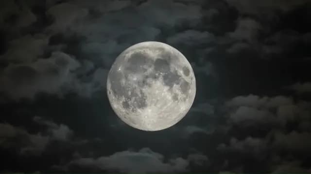 Detailed Full Moon Glowing Through Dark Night Clouds