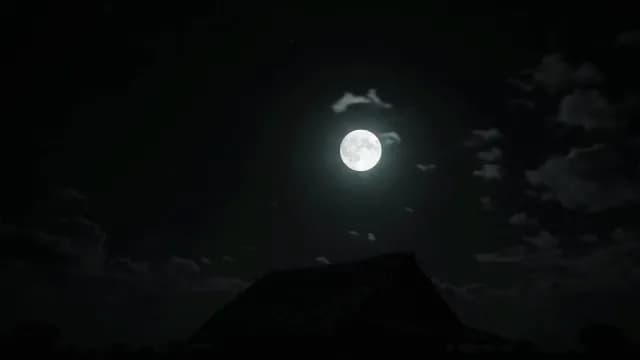 Full Moon Shining Over Silhouette of Thatched Roof Hut at Night