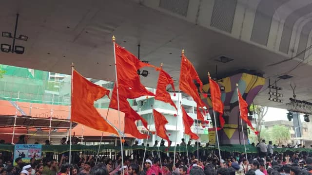 Vibrant Saffron Flags Waving Above Crowd During Cultural Procession in Chopta, Uttarakhand, India