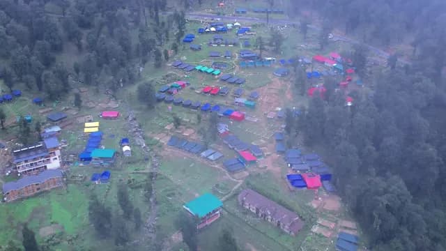 Aerial View of Colorful Mountain Campsite and Village in Misty Landscape Chopta, Uttrakhand