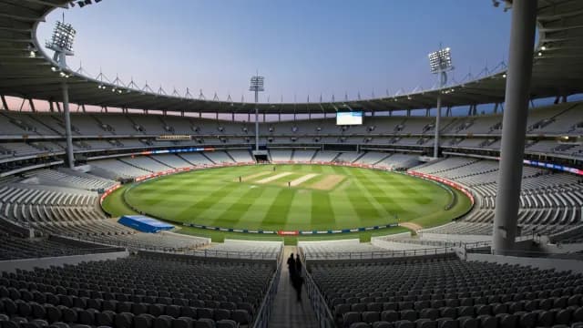 Empty Cricket Stadium Interior Under Evening Sky