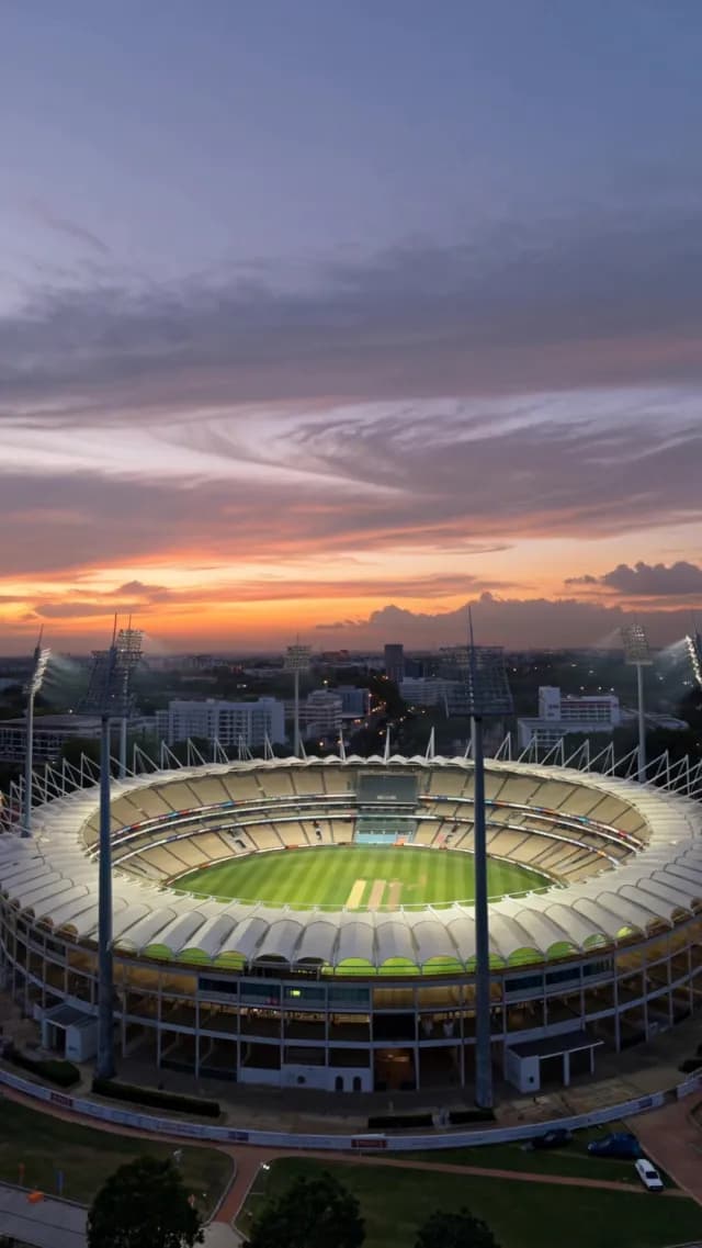 Aerial Sunset View of Illuminated Cricket Stadium