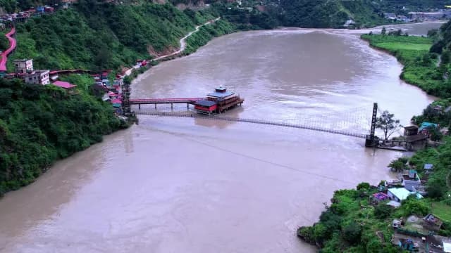 Aerial View of Long Suspension Bridge Over the Ganges River