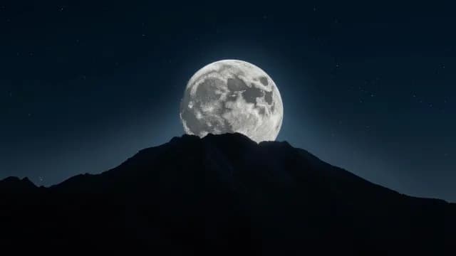 Cinematic Full Moon Rising Behind Dark Mountain Peak at Night