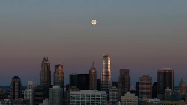 Full Moon Over Skyline During Golden Hour