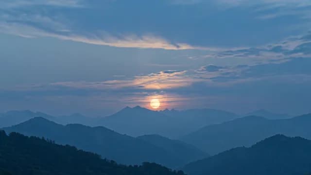 Cinematic Golden Sunrise Over Misty Blue Mountain Layers