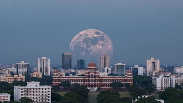 Supermoon Rising Over Historic Indian Architecture and Modern City Skyline