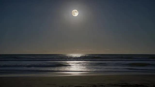 Full Moon Shining Over Night Ocean Waves