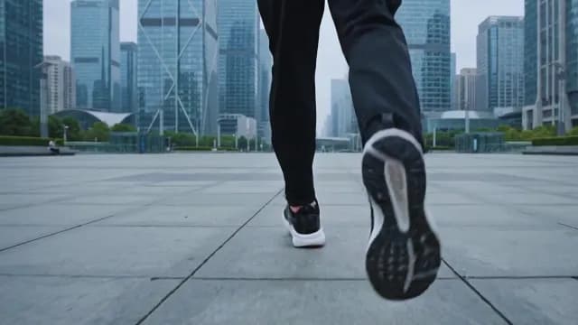 Low-Angle Shot of Person Jogging in Modern Urban Business District