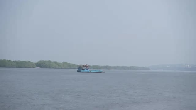 Blue Passenger Ferry Navigating Through Calm River Water