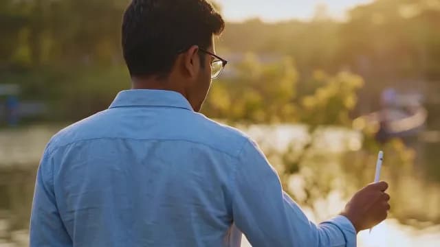 Creative Professional Using Digital Stylus Pen Near Lake at Sunset