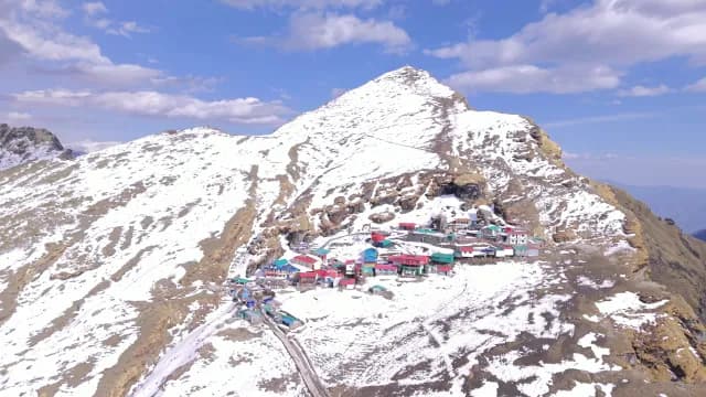 Aerial View of Colorful Tungnath Village on Snow-Capped Chopta Uttarakhand