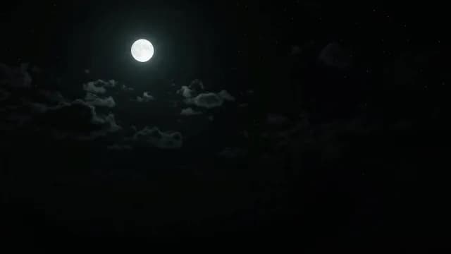 Full Moon Shining Brightly in Dark Starry Night Sky with Clouds