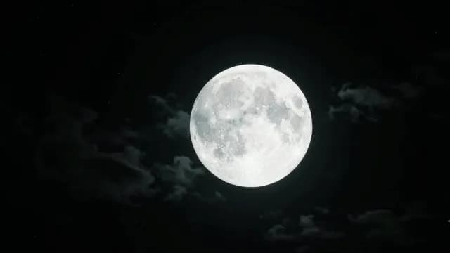 Glowing Full Moon in Dark Night Sky with Wispy Clouds